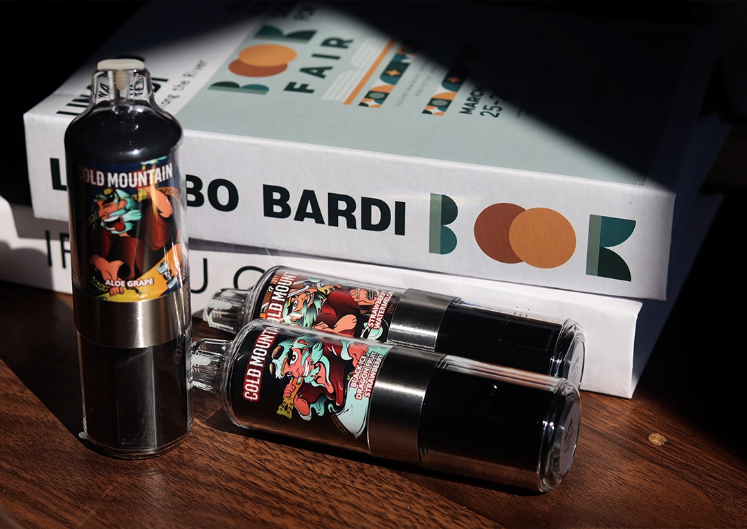 Vape products on table with books