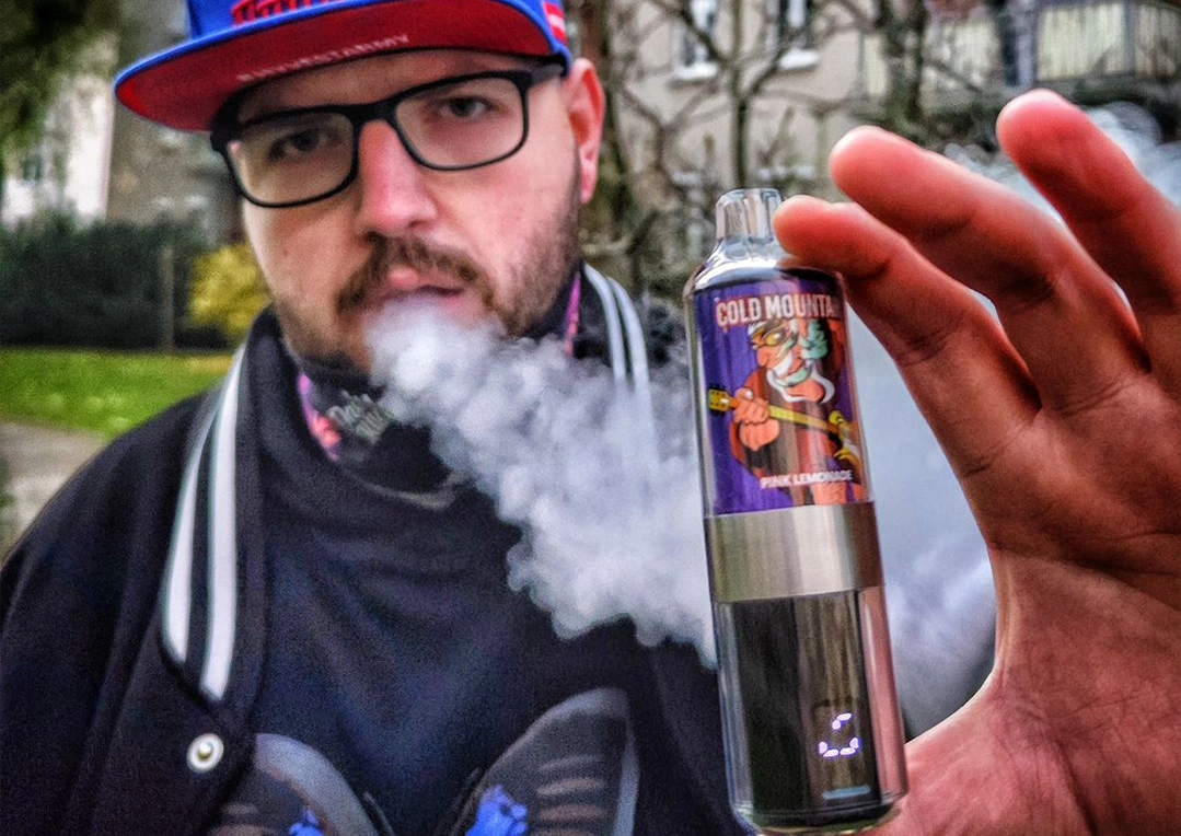 Man vaping with vapor cloud